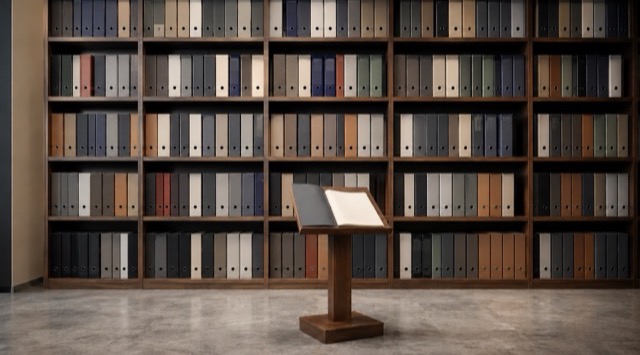 Course cover AI in Accounting and Finance: wall of shelves holding many identical file binders, with a reading stand and an open folder in front (AI generated)